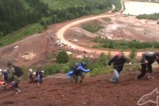 Fans help the fallen riders near the top reach the summit