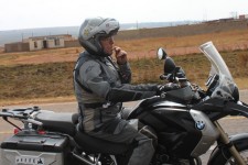 Valerio takes a nibble on a biscuit while riding Valerio takes a nibble on a biscuit while riding